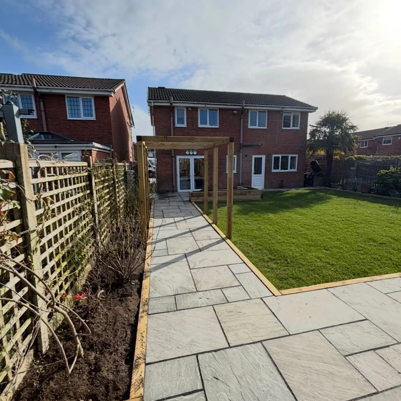 Completed garden landscaping with new lawn, paving and timber pergola in Cheshire